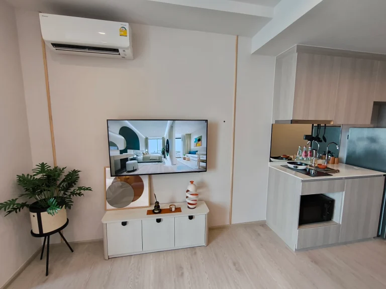 Reference Sathorn - Wongwianyai luxury condominium studio actual condo unit wall mounted TV and compact linear kitchen area